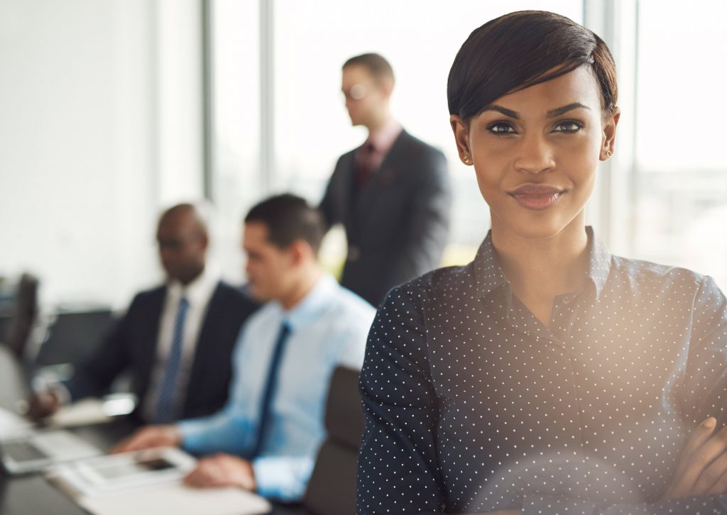 Young business owner in office with employees